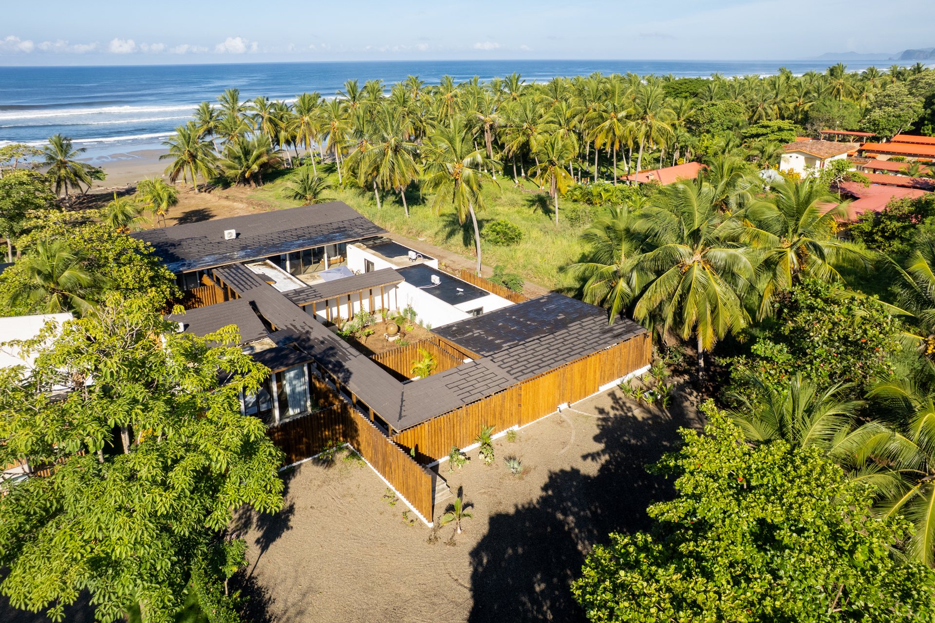 Aerial of the property and palm-lined Pacific, Playa Coyote