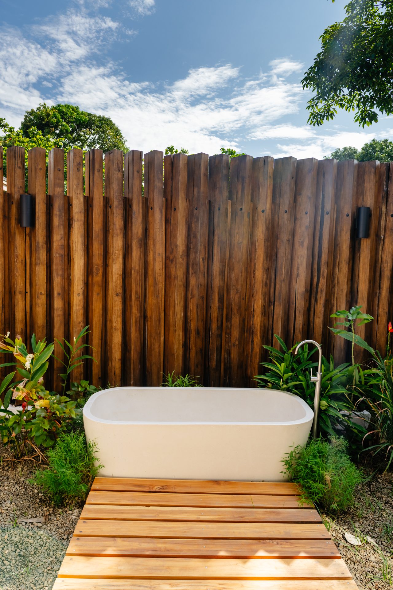 Outdoor stone soaking tub set in a bamboo-walled bath garden, Mar del Sol beachfront family villa Playa Coyote Costa Rica