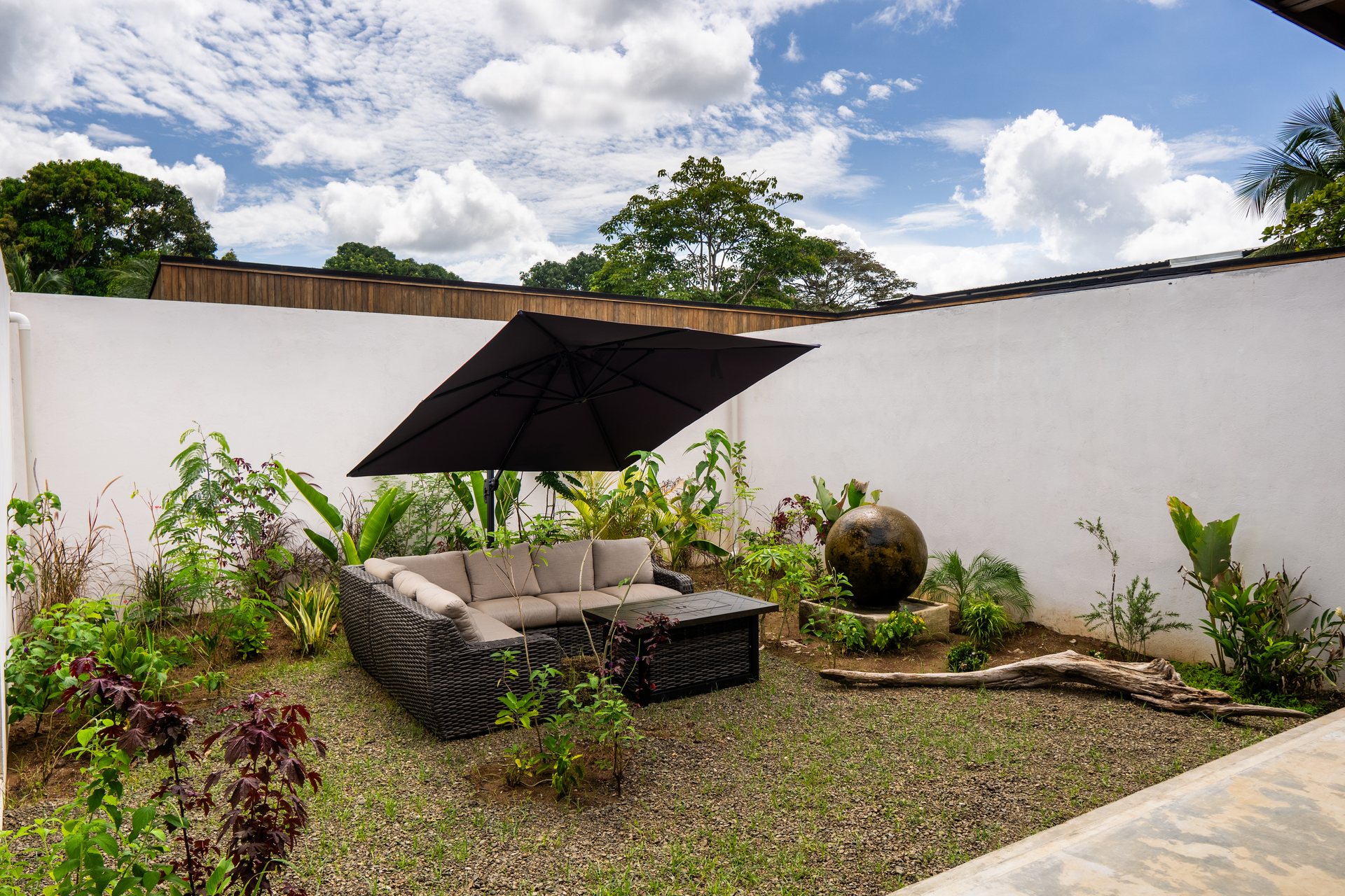 Interior patio with sectional sofa, umbrella and fire bowl, Mar del Sol beachfront villa