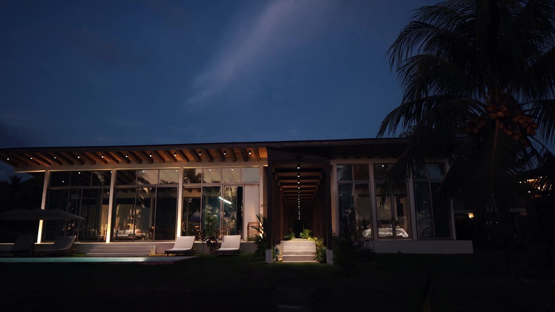 Pool and lit house at twilight, Mar del Sol Costa Rica